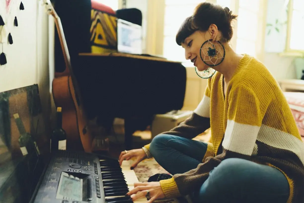 A musician playing a keyboard at home